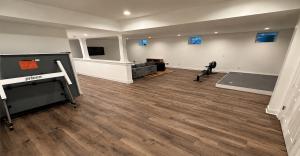 Finished basement with light wood flooring