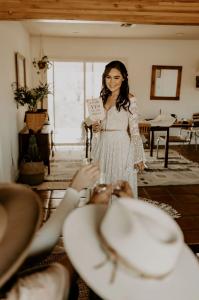 bride-tries-wedding-dress-on-at-home-Dreamers-and-Lovers