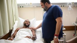 Olympiacos FC President Evangelos Marinakis visited forward Ayoub El Kaabi at the hospital following successful surgery on the leg injury the Moroccan international sustained during the club's recent match against Volos two men in a hospital room