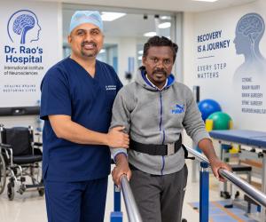Dr. Mohana Rao Patibandla, Founder and Chief Neurosurgeon at Dr. Rao's Hospital – International Institute of Neurosciences (IIN), assisting stroke survivor Ayub during early walking rehabilitation and neurorehabilitation after stroke recovery in Guntur, A