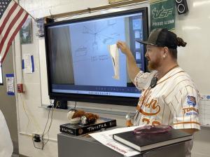 Teacher showing a piece of artwork