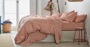 Beddora pink bedding set with pillows in a comfortable bedroom