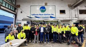 Johnny Duong, Chief Operating Officer of California Waste Solutions, center, with CWS employees at the company’s Oakland facility.