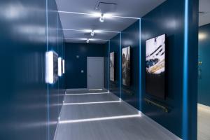 Guests walk through a tunnel flanked by video and images of the stadium from day one to present day.