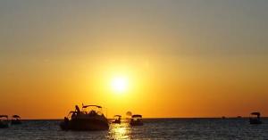 Boats at sunset off the coast of Ibiza near Sant Antoni de Portmany