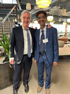 Hiten Bhuta standing with an international business professional at a European expansion event in Atlanta.