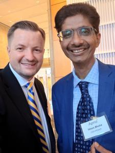 Hiten Bhuta speaking with a business professional during an international business event in Atlanta.