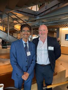 Hiten Bhuta and event speaker Ben Eason standing together during a business program in Atlanta.