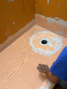 Kerdi shower pan and integrated drain with banded floor-to-wall seams on a Venice FL shower before tile installation