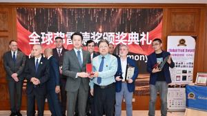 Mr. Qi Chong receiving the Global Fred Award Medal