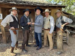 Presentation by Buck Montgomery along with three other western actors, all dressed in classic western attire with hats, boots, and six-shooter guns to John Goodwin at the Wild West Fest in Little Hollywood, Kanab, Utah, in celebration of the 90th annivers