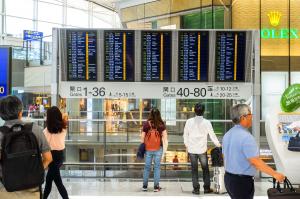 Air passengers navigating their way in an airport terminal