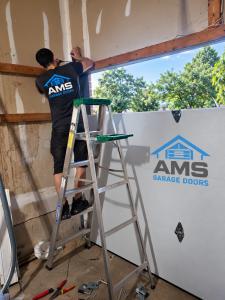 AMS Garage Doors technician performing residential garage door repair in London, Ontario