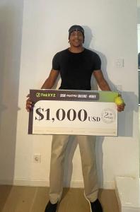 Motaku with his $1,000 second-place prize check