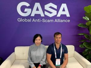 Tomomi Tanaka of Behavioral AI Lab and Andre Leung of Aereve seated together in front of the Global Anti-Scam Alliance (GASA) sign at the GASA Summit in San Francisco.
