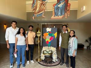 Hiten Bhuta standing with community members beside an India-themed artwork and traditional ceremonial display during Atlanta India Festival 2026.