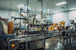 Automated high-speed supplement bottling conveyor line inside Vox Nutrition's cGMP manufacturing facility.