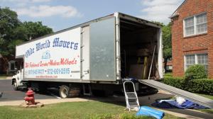 Olde World Movers moving truck parked outside a residential property