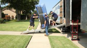 Olde World Movers crew loading wrapped furniture into a moving truck
