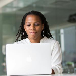 Creative Repute, a Philadelphia-based branding and creative agency, has published a step-by-step guide to launching a new company, covering the sequence of decisions that shape how ready a launch feels to the audience seeing it for the first time A woman with long braids sits at a laptop in a glass-walled office, focused on her screen