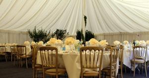 An event tent showing furnishings, decorations and flowers.