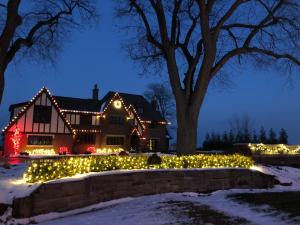 Professional Christmas lighting transforms this Cleveland-area home into a warm and festive holiday display.