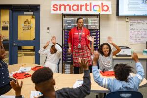 Dr. Ghantel Perkins, Assistant Superintendent for Teaching and Learning at Crete-Monee School District 201-U, engages with elementary students in the SmartLab at Crete-Monee Elementary School.