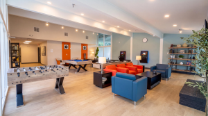 Spacious  indoor lounge area with games, billiards, foosball and seating