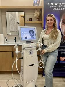 Donalda Murcaj of Donna Aesthetics standing beside the Candela Matrix platform in a treatment room