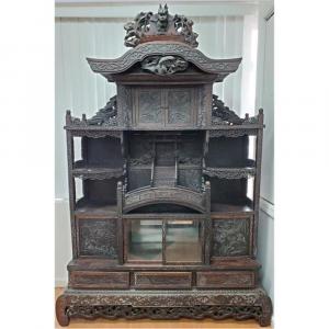 Antique Japanese carved wood etagere, circa 1880s, 89 inches tall with decorations of Mount Fuji, cranes, dragons and birds (estimate: $3,000-$4,000).