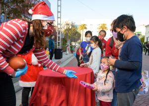 Lady Santa giving presents to children