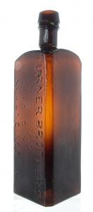 Square, red amber whittled Turner Brothers bottle with an applied top with graphite pontil and showing both Turner Brothers locations (Buffalo and San Francisco). ($3,910).