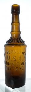 This Dr. Wonser’s USA Indian Root Bitters bottle with an applied top, medium amber in color and showing lots of uneven glass and whittle, graded 9.5 ($15,525).