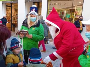 Santa and TWTH volunteers distributing books in France to children