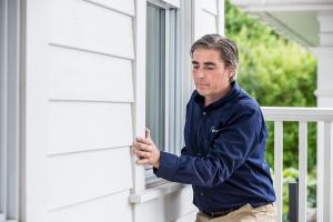 Home Inspector Checks Window Frame for Air Leaks