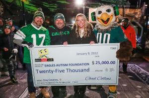 Brick Fest Live presenting contribution check to Eagles Autism Foundation and Eagles mascot SWOOP