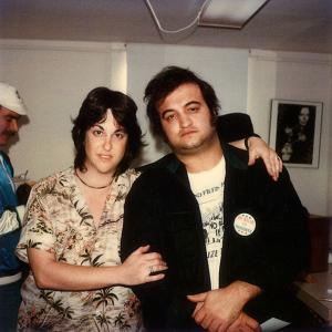 A photo of Rolling Stone photographer Bonnie Schiffman (left) with actor and comedian John Belushi (right) taken in 1980 at Schiffman’s Los Angeles studio to promote the Steven Spielberg film 1941 starring Belushi as “Capt. Wild Bill Kelso.”