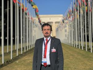 Dr. Florian Kongoli at Flag Alley amongst 194 national flags at Palace of Nation, United Nation Headquarters, Geneva, before giving his opening plenary lecture