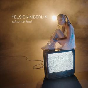 Kelsie Kimberlin Sitting On A TV With Static