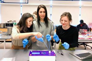 3 women designers/students learning biotechnology using the DNA Playground at Parsons NY