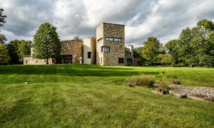 This contemporary masterpiece features bright, skylight-lit corridors and panels of enormous glass that look out onto both the stone courtyard and verdant lawns.