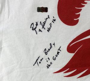 A Tampa Bay Buccaneers T-shirt worn by NFL Hall of Fame quarterback Brett Favre at this year’s game between the Buccaneers and the Carolina Panthers on September 20th – signed by Favre with “HOF 16” (for his induction into the Pro Football Hall of Fame in 2016) and “Tom Brady is the GOAT” (the acronym for “Greatest of All Time”) – is up for bid in an online-only auction being held by Pristine Auction