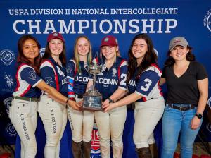 UCONN Women's polo team holds Championship trophy