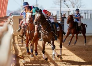 Texas Tech and UCONN arena polo players battle for the ball in USPA National Intercollegiate Championship