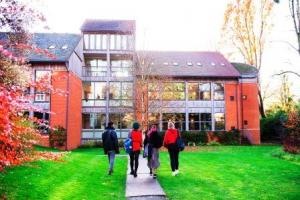 Students walking on campus at Lucy Cavendish College, University of Cambridge, UK