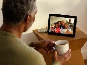 Veterans Home Care (VHC) has issued several warning signs for children of aging parents to watch for during the holiday season Black senior citizen watches screen as he video chats with family.