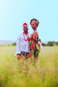 Singer Elle B with husband and collaborator, Kelechi A. pose in field in traditional Nigerian clothing