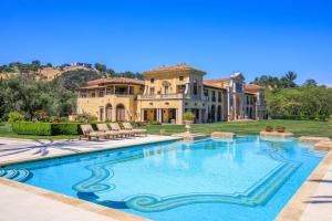 Entertain a slice of European lifestyle with resort amenities galore including a pool with pool house and outdoor tennis court.