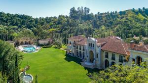 A walking/jogging trail meanders the perimeter of the estate and its sweeping four plus-acre, exceptionally manicured backyard.