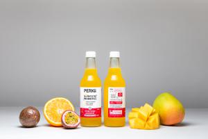 PERKii Sparkling Orange, Mango Passionfruit bottle with fruit.